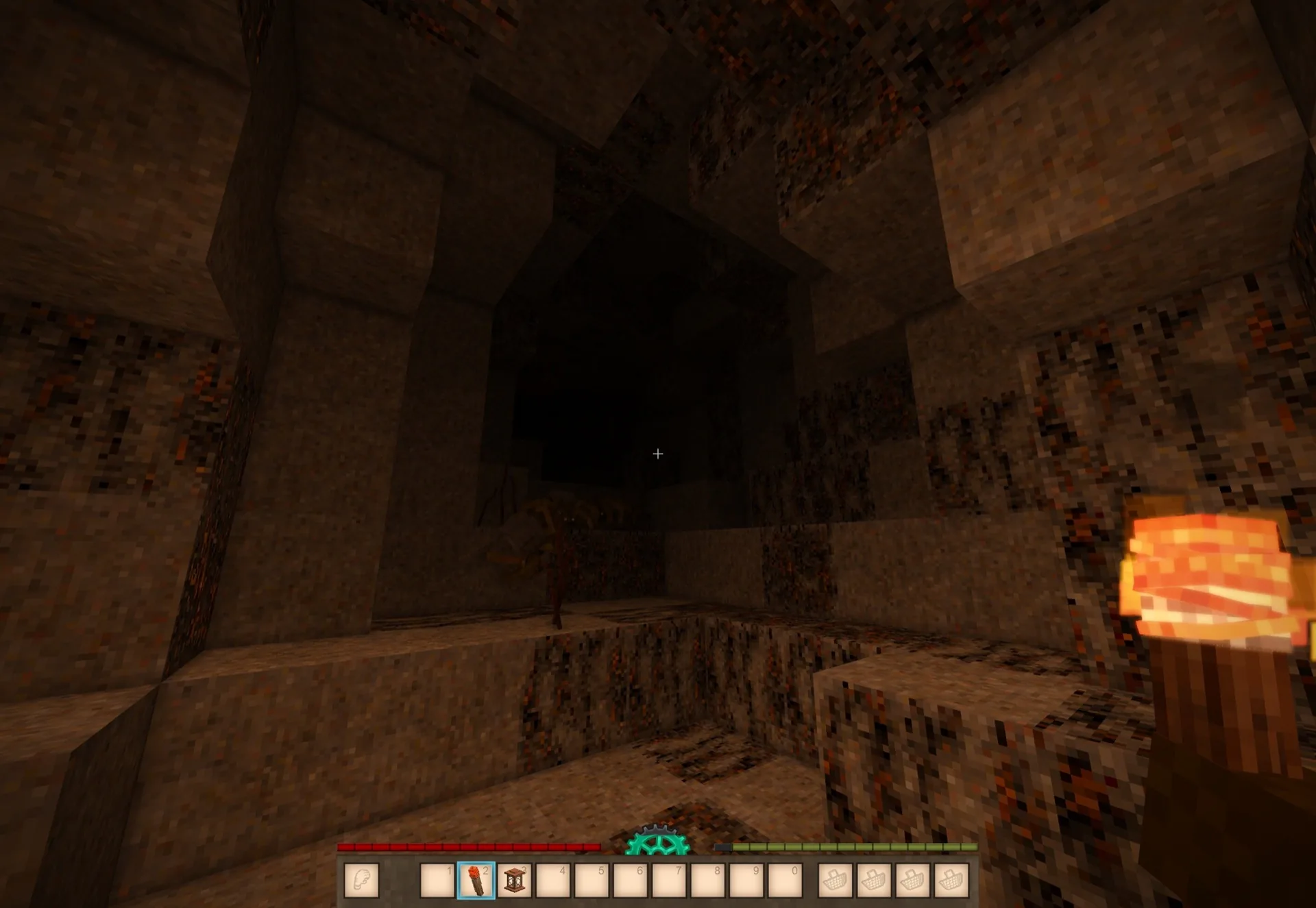 A torch-lit cave encounter in Vintage Story with the HUD visible.
